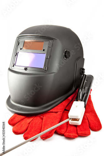 Protective welder mask, electrode and gloves on white background