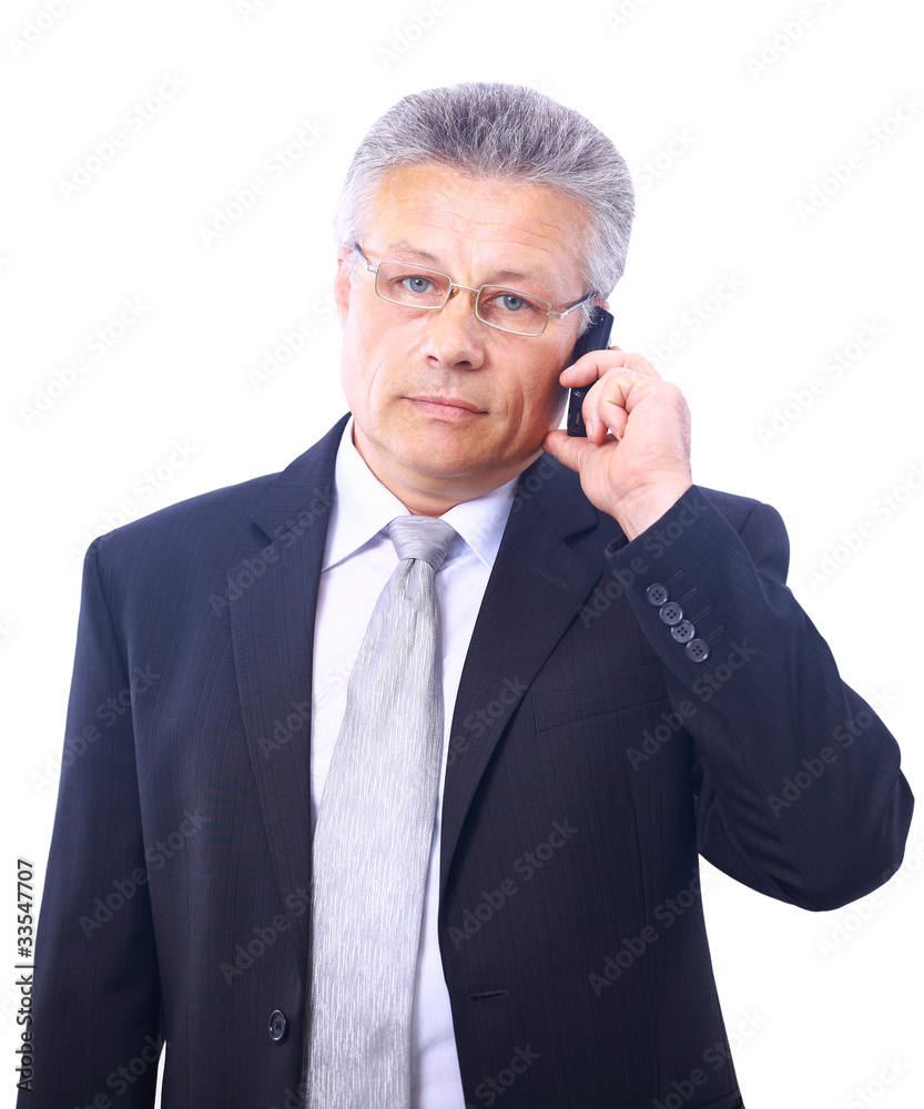 Mature executive talking on mobile phone isolated on Mature executive talking on mobile phone isolated on