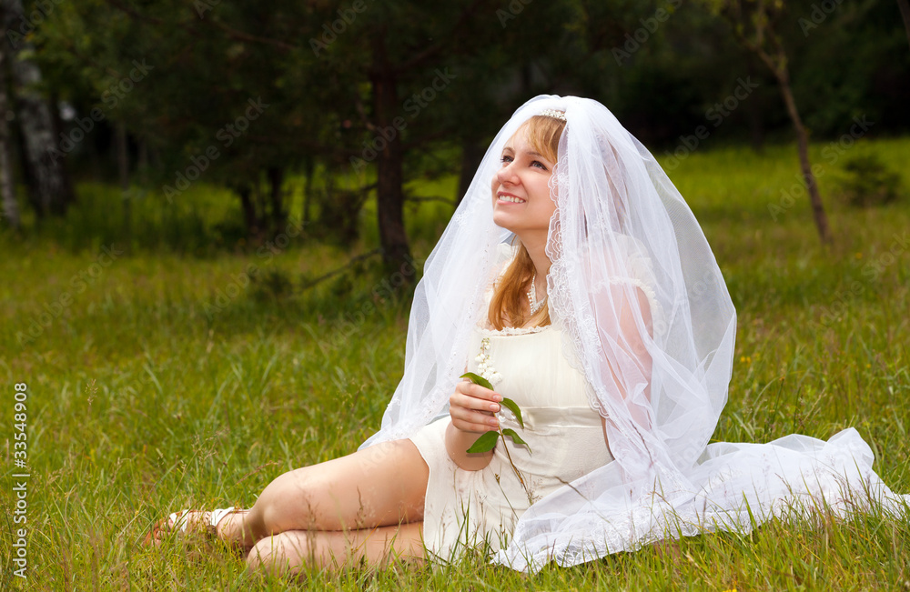 happy girl in wedding dress in park