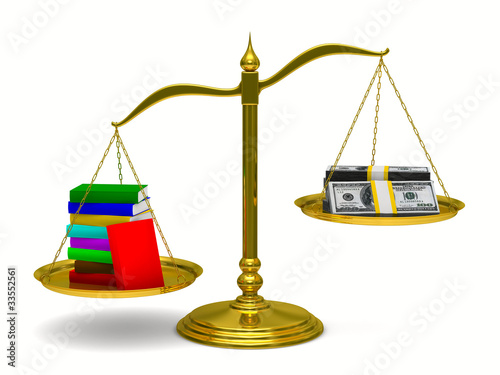 Books and money on scales. ...