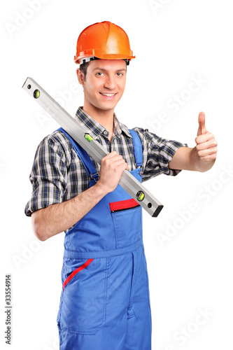 Worker holding a construction bubble level and giving thumb up
