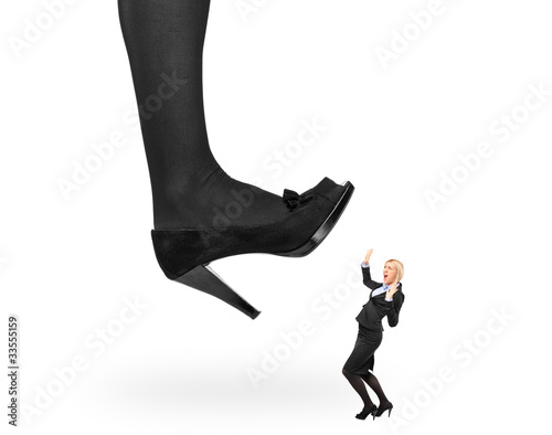 Big woman shoe stepping on an affaraid businesswoman