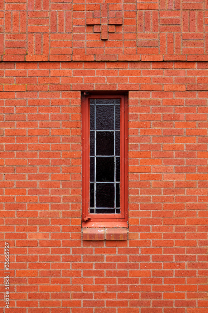Single narrow window in brick wall