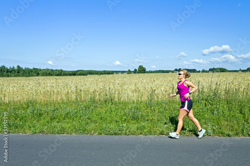 Running woman on summer country road