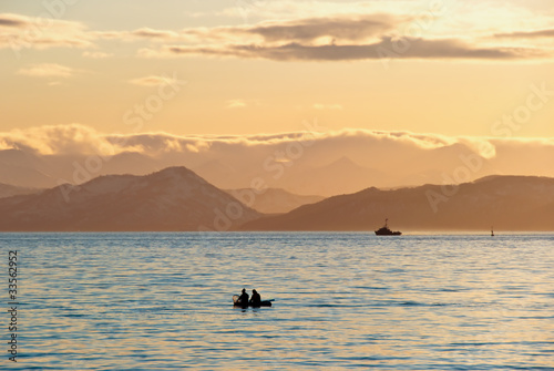 Fishermen boat in sunset