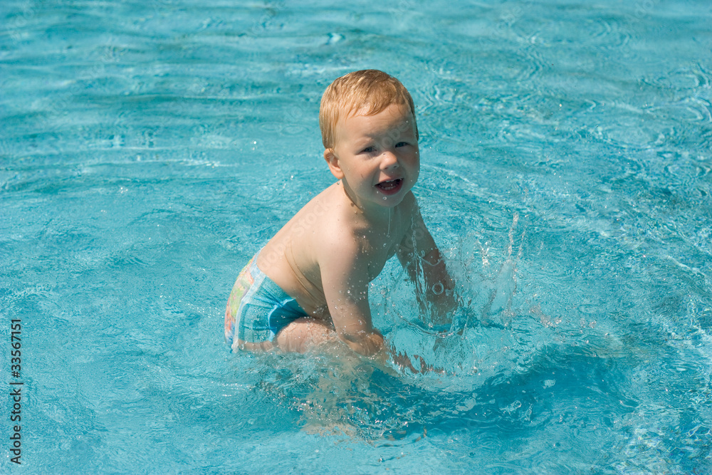 child in a swimming pool child in a swimming pool