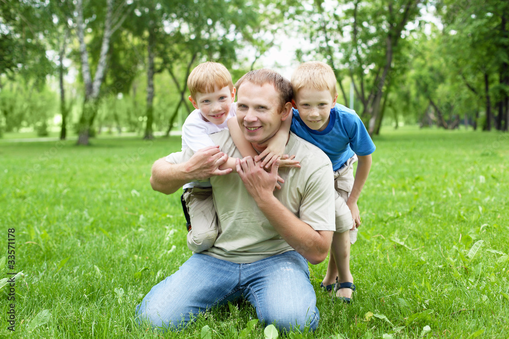 Portrait of father with two sons outdoor Portrait of father with two sons outdoor
