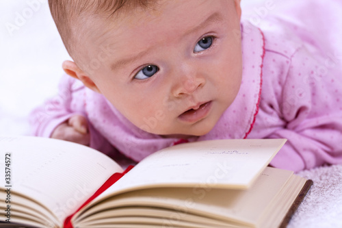 Newborn baby with a book photo