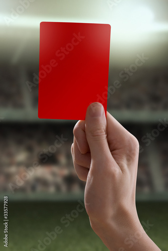 Red card with hand from referee giving a penalty