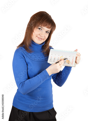 Girl is marking a day on one's calendar photo