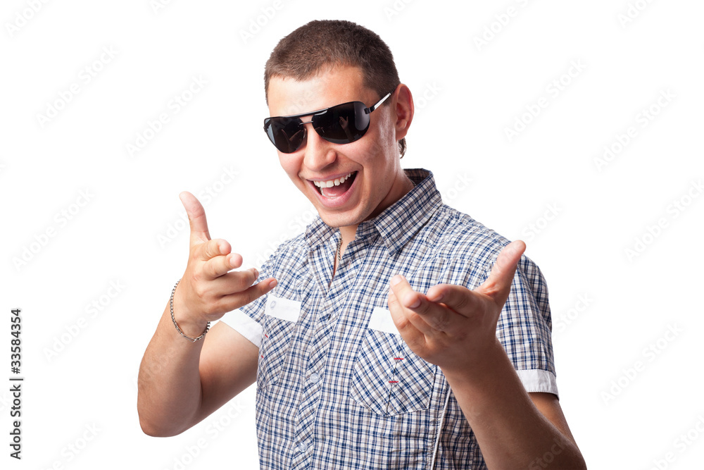 Naklejka premium smiling happy young man in sunglasses shows forefingers isolated