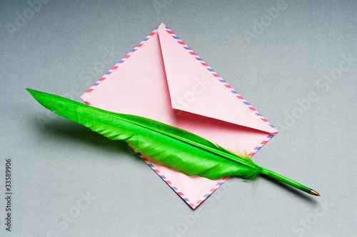 Letter and feathe isolated on the white photo