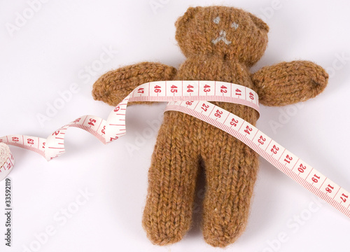 teddy bear with measuring tape photo