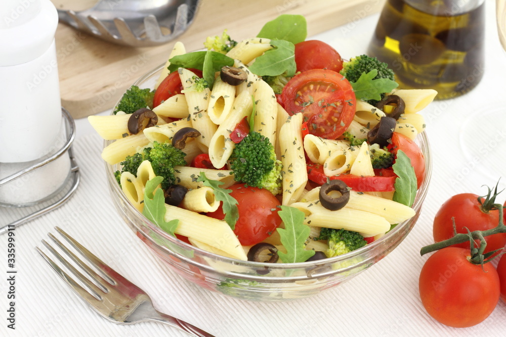 Penne pasta salad with vegetables and herbs