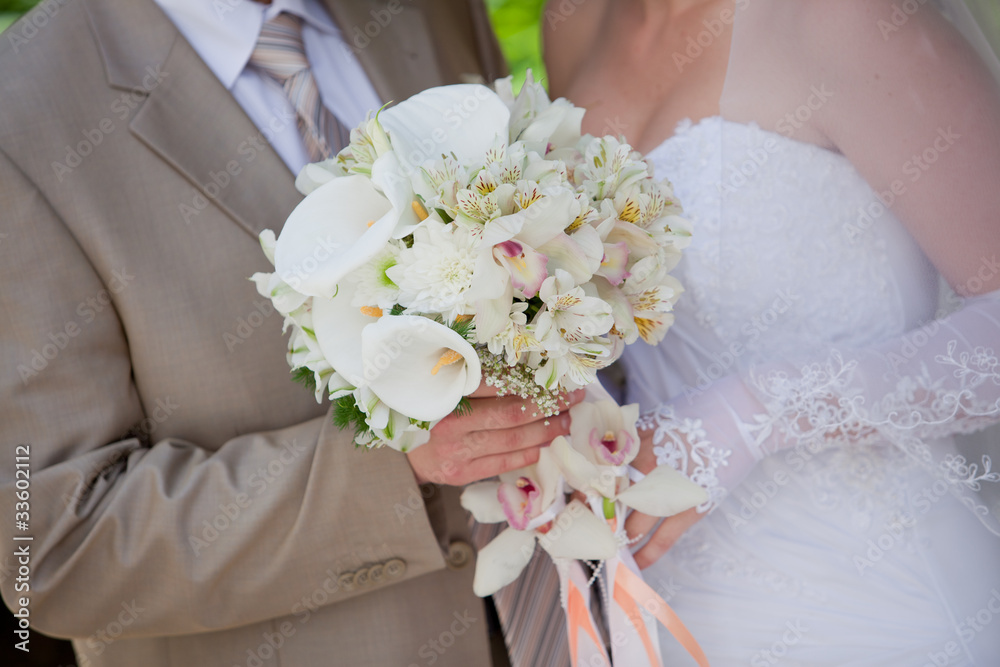 groom and bride holding wedding bouquet groom and bride holding wedding bouquet