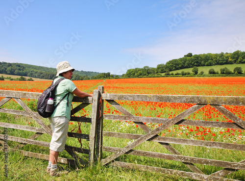 Lady Hiker by a Field of Red Poppies