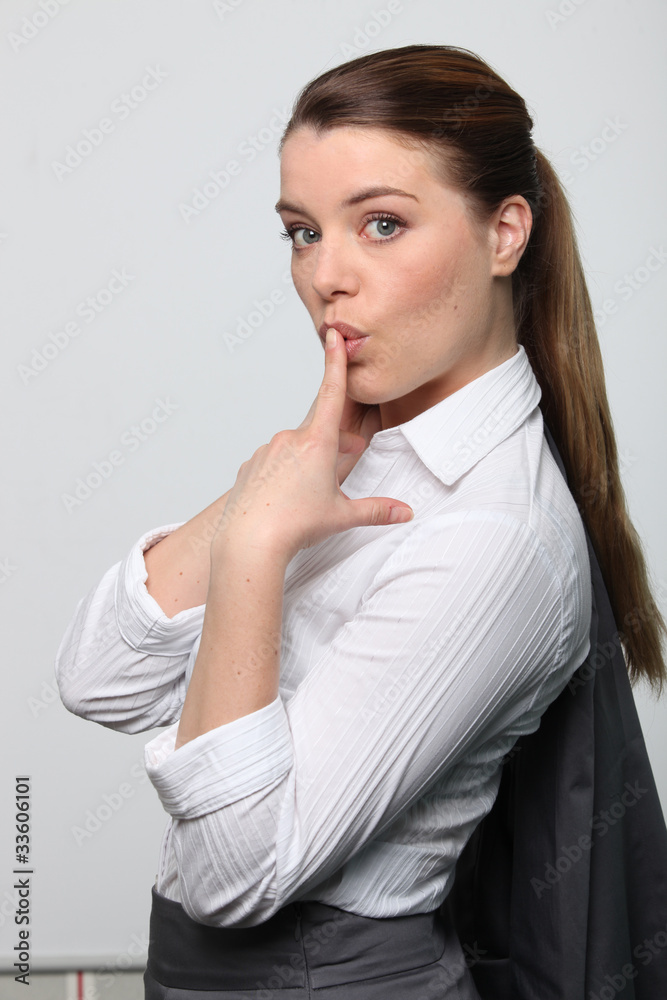 Portrait of cute female executive with jacket slung Portrait of cute female executive with jacket slung