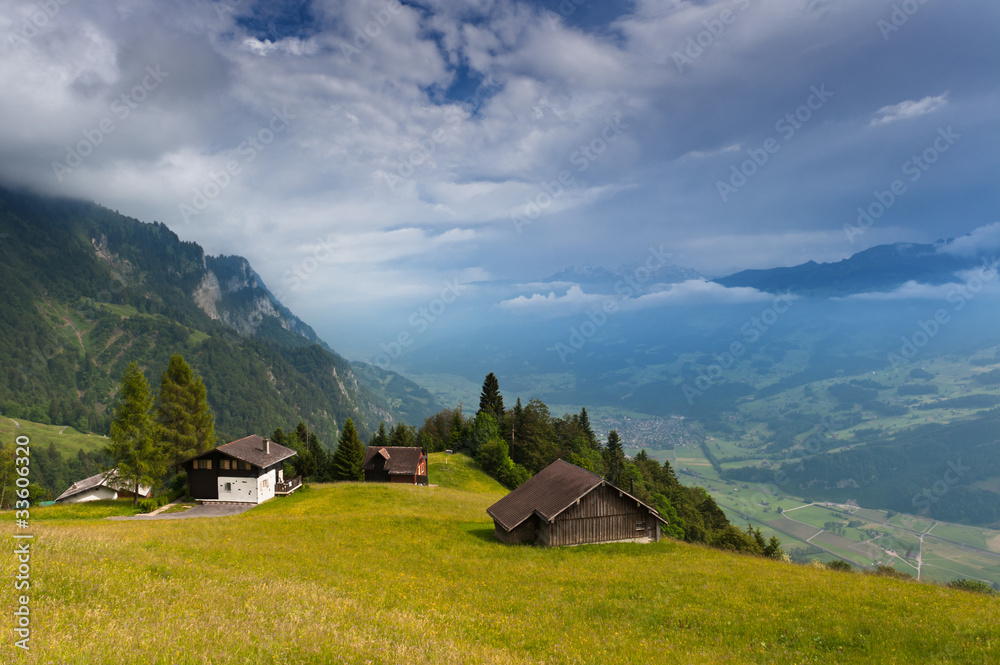 Alpine country houses in Swiss Alps. St. Gallen, Switzerland.