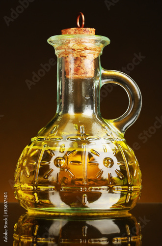 jar with olive oil on a yellow background