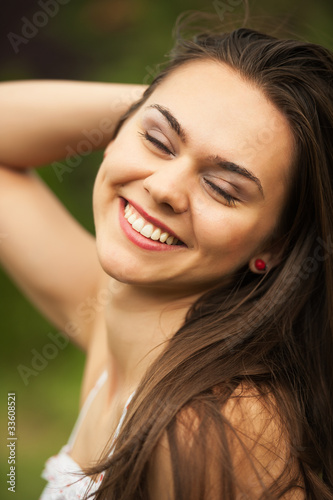 Closeup portrait of a beautiful young woman having a happy thoug