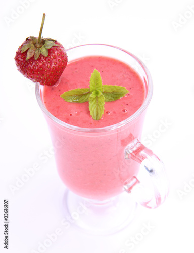 Strawberry shake in a glass with a strawberry and mint