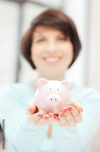 lovely woman with piggy bank