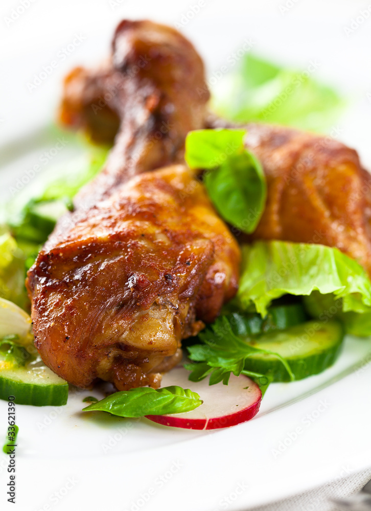 Roasted chicken legs with salad and fresh herbs
