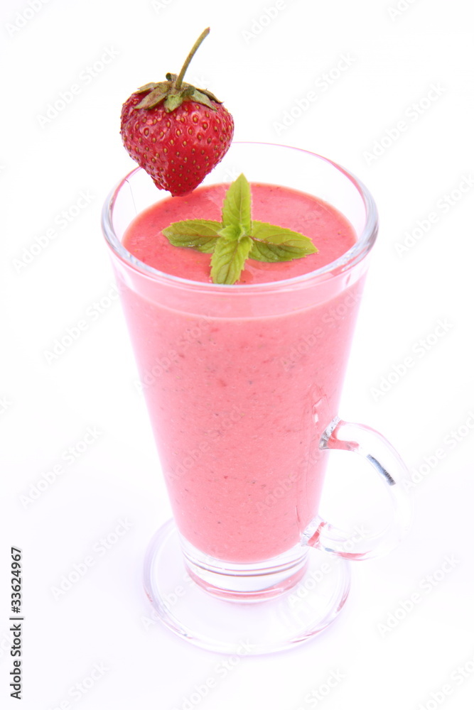 Strawberry shake in a glass with a strawberry and mint Strawberry shake in a glass with a strawberry and mint