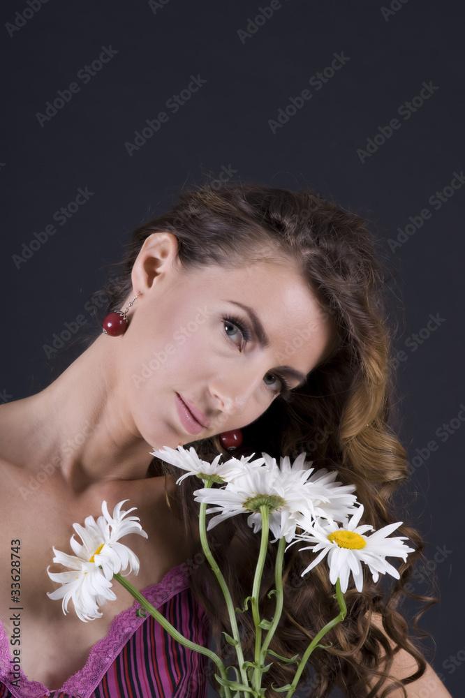 Beautiful young woman with camomile