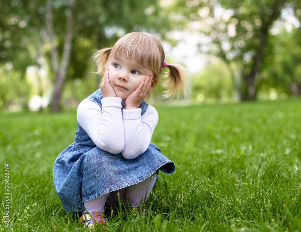 Fototapeta premium Portrait of a little girl outdoors