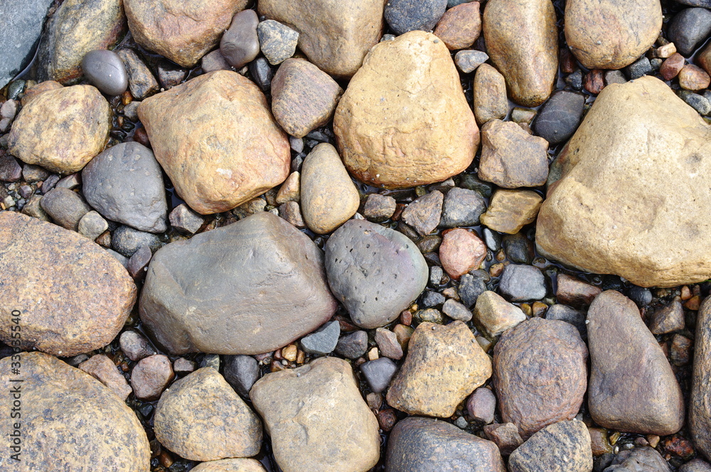 Picture stones on a sea bottom in low-tide water Picture stones on a sea bottom in low-tide water