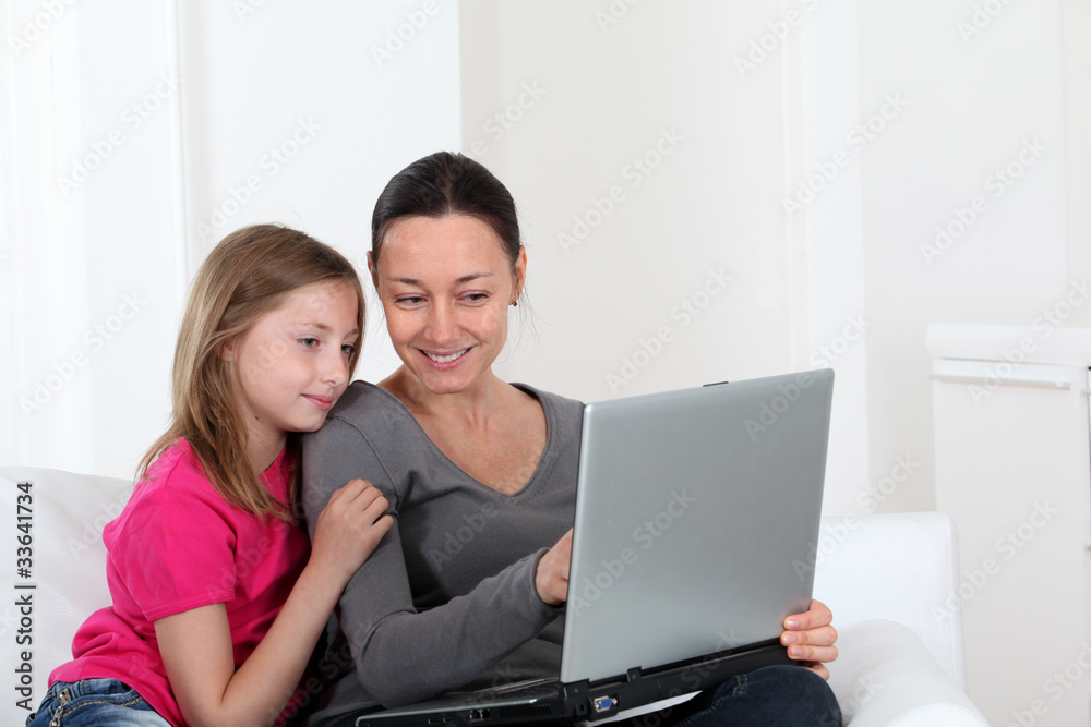 Mother and daughter using laptop computer at home Mother and daughter using laptop computer at home