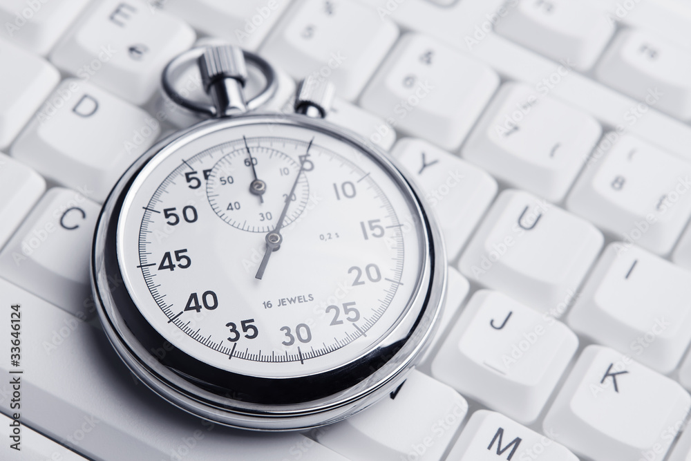 Stopwatch on white keyboard Stopwatch on white keyboard