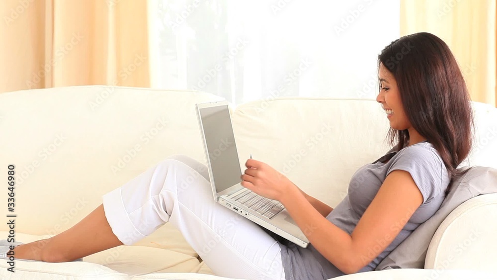 Charming brunette working with her laptop Charming brunette working with her laptop