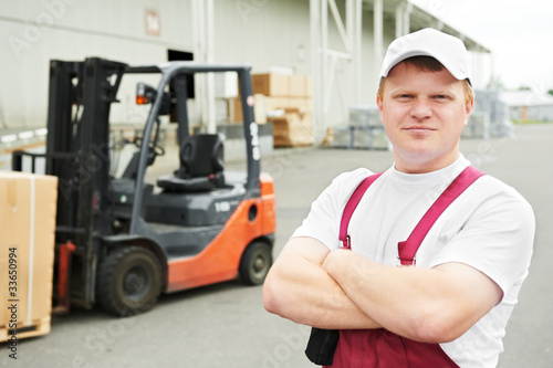 warehouse worker in front of forklift
