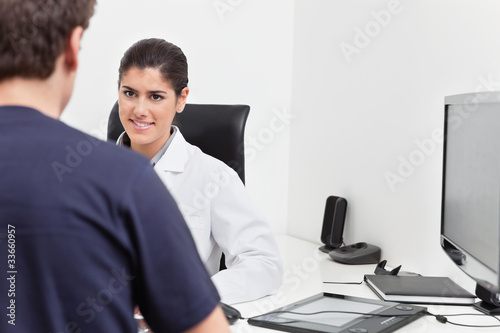 Smiling Female Doctor Talking to Patient