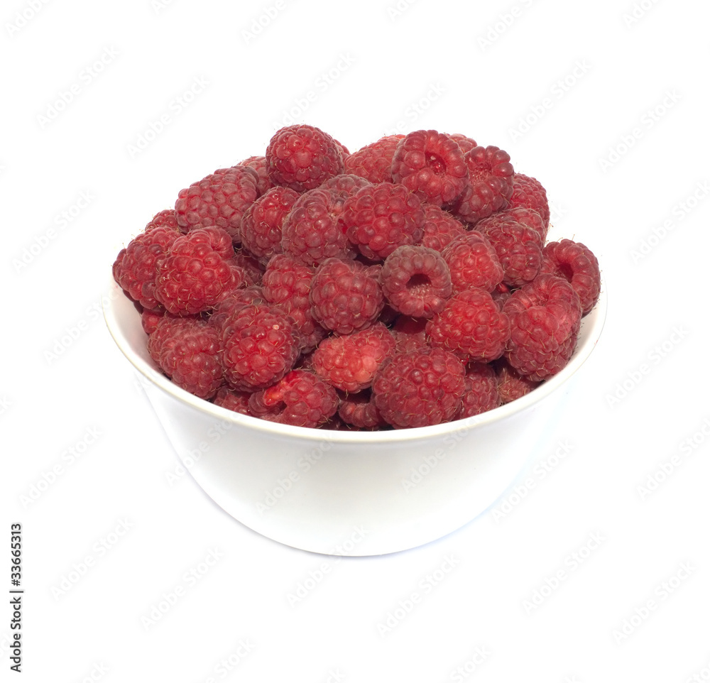 Many tasty fresh raspberries in white dishes closeup isolated Many tasty fresh raspberries in white dishes closeup isolated