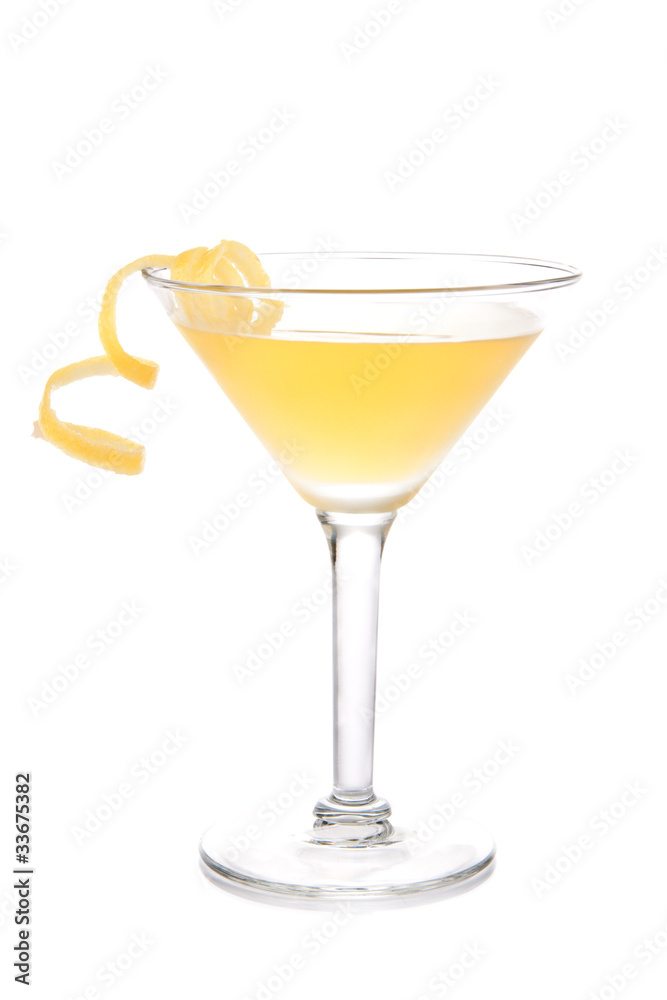 Yellow banana cocktail in martini glass with lemon twist
