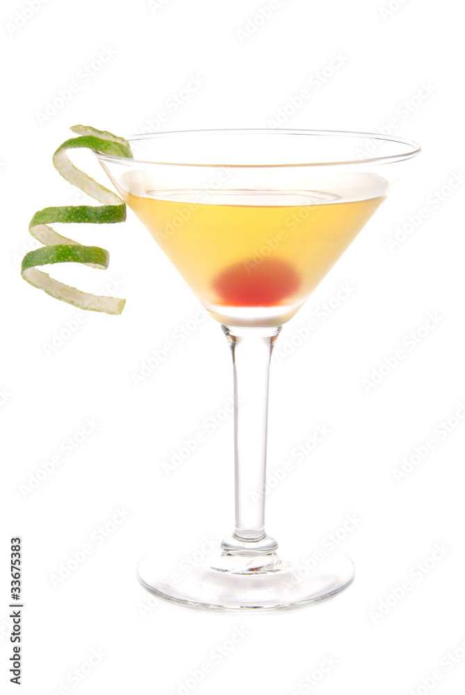 Yellow banana martini cocktail in martinis glass with lime twist