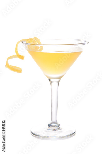 Yellow banana cocktail in martini glass with lemon twist