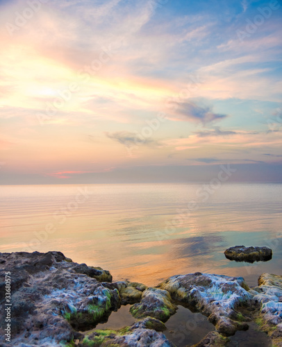 Sea and rock at the sunset. Seascape composition.