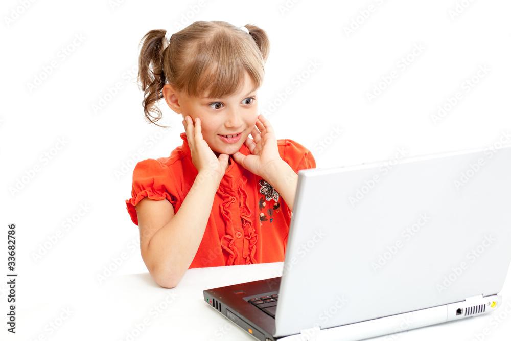 Surprised schoolgirl sitting at notebook isolated on white Surprised schoolgirl sitting at notebook isolated on white