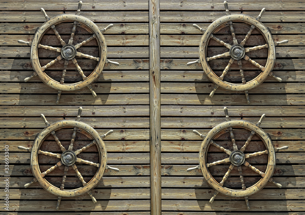 Steering wheels of the ship on a wooden wall