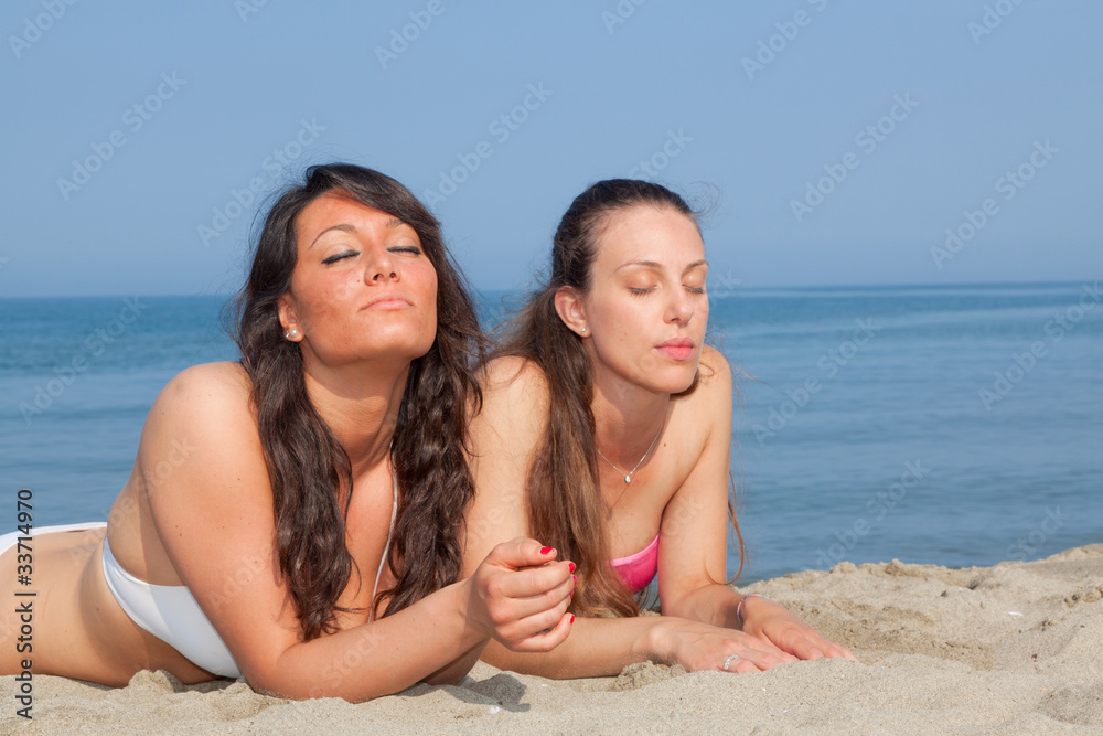 Fototapeta premium Two Young Women Sunbathing
