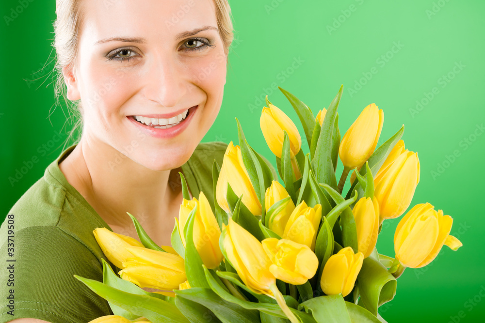 Young happy woman hold yellow tulips flower Young happy woman hold yellow tulips flower