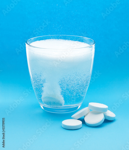 Effervescent tablet in glass of water with bubbles