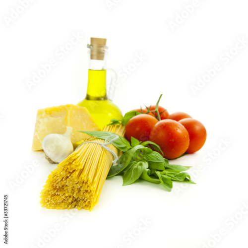 Ingredients for Italian cooking: basil, tomato, parmesan, garlic