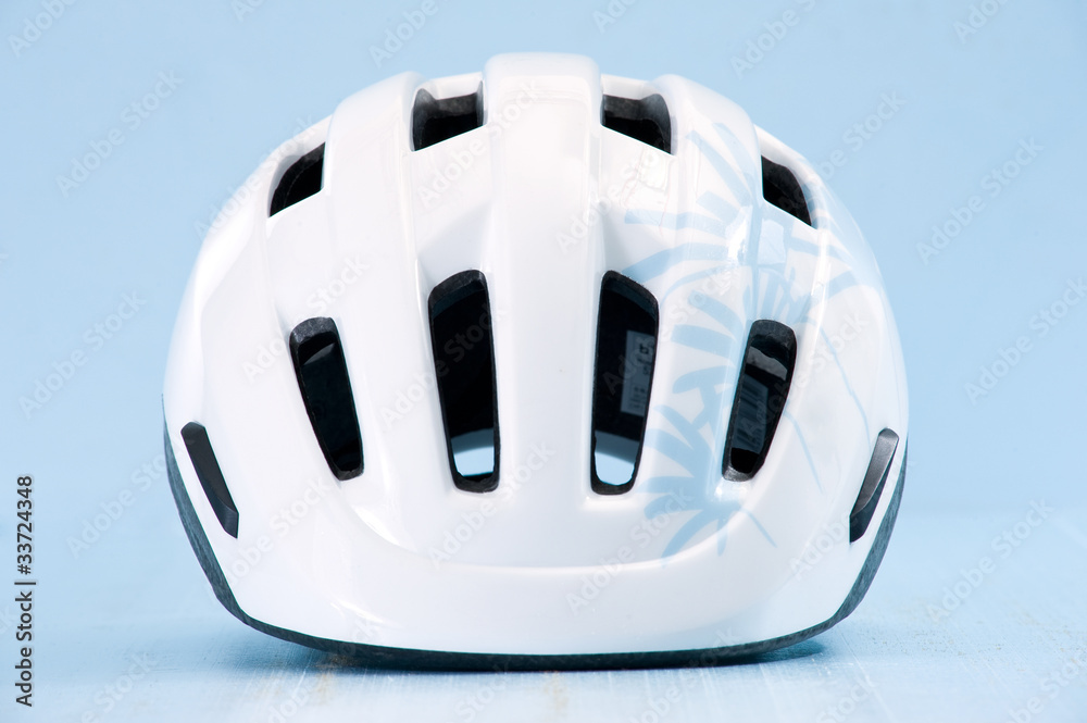 Fototapeta premium White bike helmet isolated on blue background. Front view.