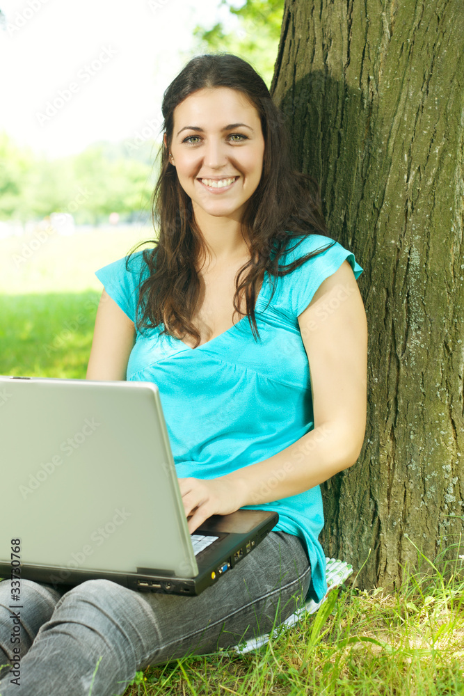 happy young woman using laptop outdoors happy young woman using laptop outdoors