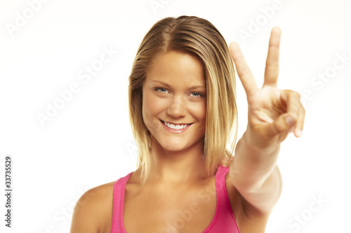 happy excited young woman showing the sign of victory